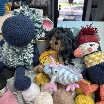 The Twisted Skein - Photos of crochet Amigurumi sheep, caveman, three-eyed monster creature, and puffin on display in the shop - Knitting Supplies Near Me - Bakersfield, California The Twisted Skein - Photos of crochet Amigurumi sheep, caveman, three-eyed monster creature, and puffin on display in the shop - Knitting Supplies Near Me - Bakersfield, California