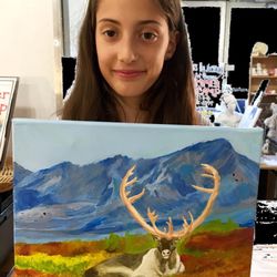 PROUD AIAVAP student holding her finished acrylic painting from observation.