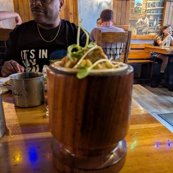 Raices Times - Art on the wall and my delicious mofongo in the foreground. - Puerto Rican Near Me - San Juan, Puerto Rico Raices Times - Art on the wall and my delicious mofongo in the foreground. - Puerto Rican Near Me - San Juan, Puerto Rico