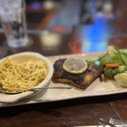 Grizzly's Wood-Fired Grill & Bar - Wood fired salmon with veggies and angel hair pasta in a Parmesan cream sauce.