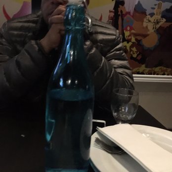 Baba Dhaba - a man sitting at a table with a bottle of water - Indian Near Me - Brampton, Ontario Baba Dhaba - a man sitting at a table with a bottle of water - Indian Near Me - Brampton, Ontario