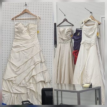 Goodwill - Several wedding dresses are displayed on hangers against a white pegboard wall, with some dresses featuring intricate embroidery and embellishments. - Thrift Stores Near Me - Fairfax, Virginia