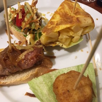 Gasterea - Tortilla, croquetas de jamón, mini hamburguesas (behind everything) and Catalan sausage with onion was a bit sweet - Basque Near Me - Barcelona, B Gasterea - Tortilla, croquetas de jamón, mini hamburguesas (behind everything) and Catalan sausage with onion was a bit sweet - Basque Near Me - Barcelona, B