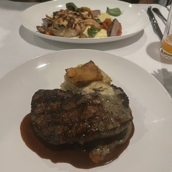 Stella's Southern Bistro - Grilled 12oz NY Strip (gratin potato's and roasted broccoli)  Alpine Chicken (on a bed of grits with Italian sausage and mushrooms) - New American Near Me - Simpsonville, South Carolina