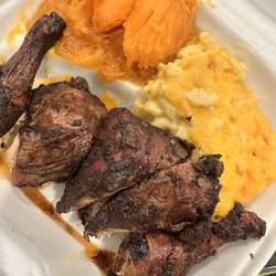 Jr's Jamaica Restaurant - Dark chicken was deliciously flavored. A bit dry but delicious. Yams were the bomb mixed Mac and cheese