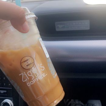Ziggi's Coffee - a hand holding a cup of iced coffee - Coffee & Tea Near Me - Westminster, Colorado