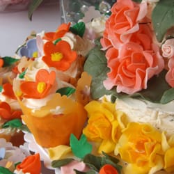 My mother in law bought the cupcake wrappers, 3-tier cake pans,  fondant (for the handmade flowers), and food dye at Jo-Ann's.