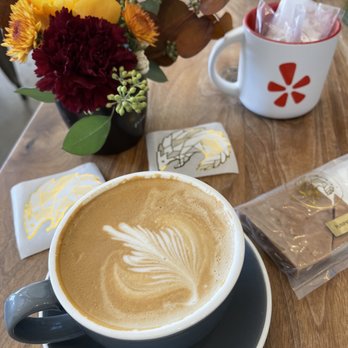 Pangolin Café - The cup of Cubano Breve Latte, Flowers by Emmy's flower truck with a Pangolin Coffee cup and confections. - Coffee & Tea Near Me - Reno, Nevada Pangolin Café - The cup of Cubano Breve Latte, Flowers by Emmy's flower truck with a Pangolin Coffee cup and confections. - Coffee & Tea Near Me - Reno, Nevada
