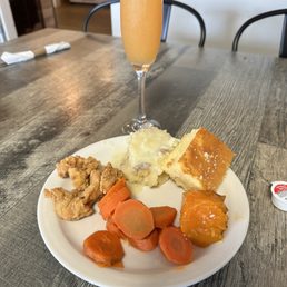 a plate of food and a glass of orange juice a plate of food and a glass of orange juice