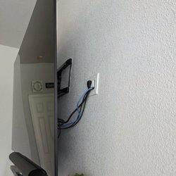 Behind the TV showing TV mount, power wires, signal wires, internet/ethernet wires and PS5 wires