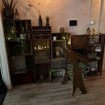 Campechano Mariscos - a room with a table, shelves, and plants - Mexican Near Me - Toronto, Ontario Campechano Mariscos - a room with a table, shelves, and plants - Mexican Near Me - Toronto, Ontario