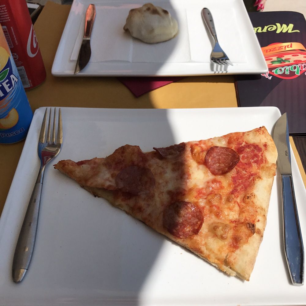 Fabio's - Slide of sausage pepperoni pizza and a buffalo calzone. - Italian Near Me - Lido di Venezia, VE