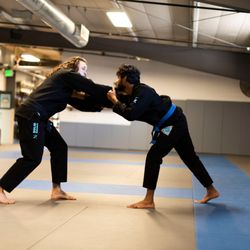 Easton Training Center - Longmont - Professor Shae demonstrates a collar grip with a student.