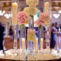 Northern Greenhouses - Place card table centerpiece collection with bouquets of peonies, roses and hydrangea anchored by towering floating and pillar candles.