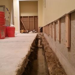 Atlantic Coast Waterproofing - Interior drainage system. Look at the water underneath this home.