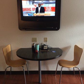 Motel 6 - Breakfast-style table with two chairs, and central flat screen tv - Hotels Near Me - Troutville, Virginia