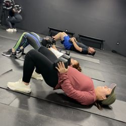 A focused workout at Haven Fitness! Clients crushing hip thrusts and squats, building strength in a motivating group environment!