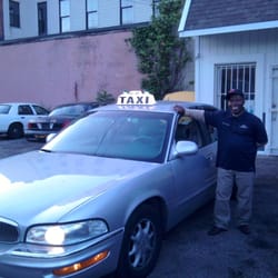 Bmk Taxi - The proud owner of the Bmk Universal Taxi Group takes a photo standing next to his first taxi cab.