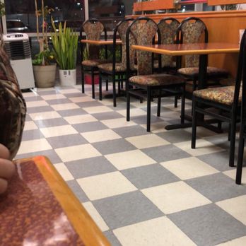 China King - a man sitting at a table in a restaurant - Chinese Near Me - Cedar Rapids, Iowa