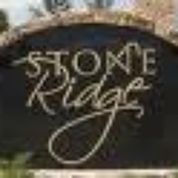 a stone ridge sign in front of a brick building a stone ridge sign in front of a brick building