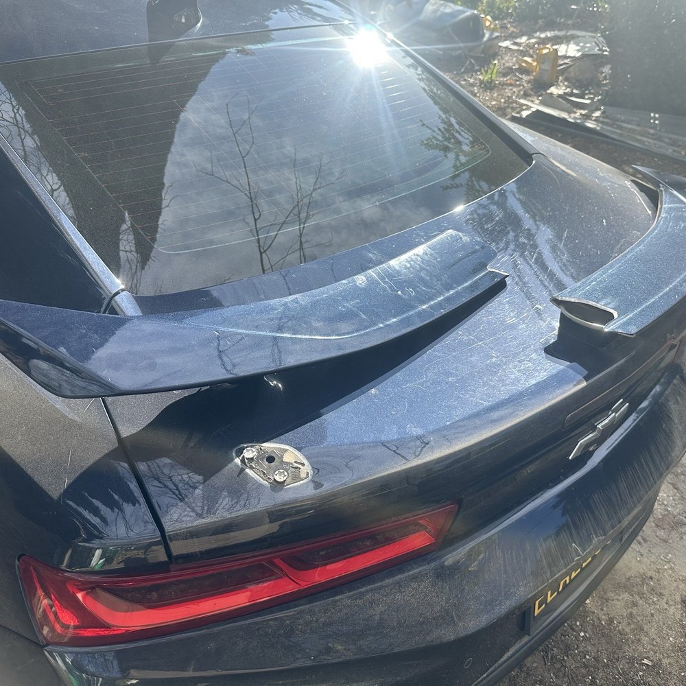 Camaro ss with half the wing spoiler ripped off from the Carwash. Camaro ss with half the wing spoiler ripped off from the Carwash.