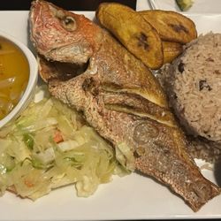 Escovitch Fish w/pepper sauce , Peas & Rice, Streamed Cabbage & plantains.
