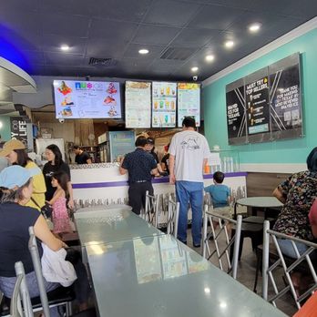 Nu Cafe - a group of people sitting at tables - Ice Cream & Frozen Yogurt Near Me - Houston, Texas Nu Cafe - a group of people sitting at tables - Ice Cream & Frozen Yogurt Near Me - Houston, Texas