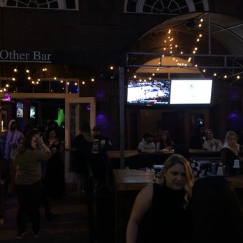 The Other Bar - a woman sitting at a bar - Lounges Near Me - Orlando, Florida