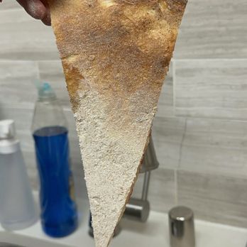 Pizza My Heart - Excess flour from bottom of pizza - Pizza Near Me - Dublin, California Pizza My Heart - Excess flour from bottom of pizza - Pizza Near Me - Dublin, California
