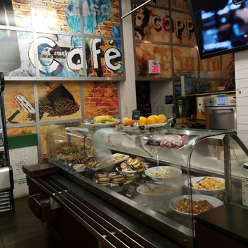 Van Houtte - a food counter with a television in the background - Coffee & Tea Near Me - Montreal, Quebec