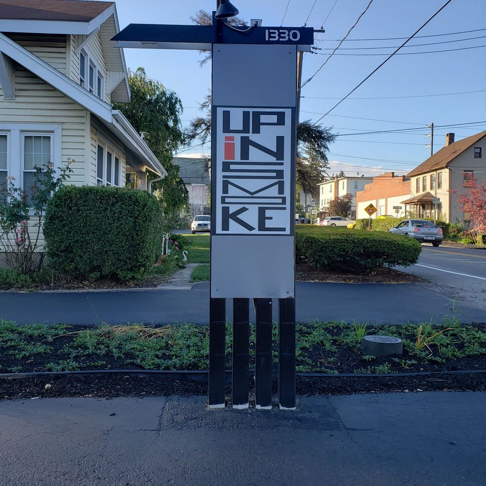 a street sign in front of a house a street sign in front of a house