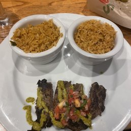 two bowls of pasta and a steak