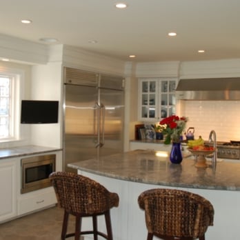 Goloudon Remodelers - a kitchen with a large island - General Contractors Near Me