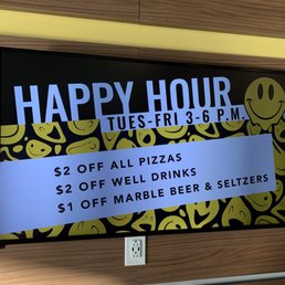 Happy hour! - A digital screen shows happy hour offers, including discounts on pizzas, well drinks, and marble beer & seltzers, with a smiley face graphic.