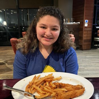 Real Seafood Company Bay City - Happy Girl with her chicken tenders - Seafood Near Me - Bay City, Michigan Real Seafood Company Bay City - Happy Girl with her chicken tenders - Seafood Near Me - Bay City, Michigan