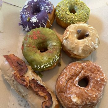 Milkee Donuts - Top Left clockwise: coconut Ube, pistachio, Vietnamese coffee, cronut, maple bacon, matcha donuts! All delicious! - Coffee & Tea Near Me - Wauwatosa, Wisconsin Milkee Donuts - Top Left clockwise: coconut Ube, pistachio, Vietnamese coffee, cronut, maple bacon, matcha donuts! All delicious! - Coffee & Tea Near Me - Wauwatosa, Wisconsin