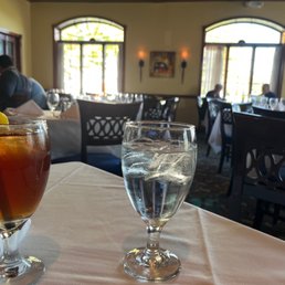 a glass of water and a drink on a table