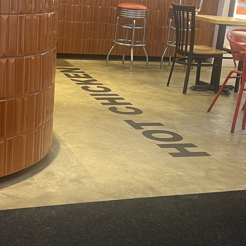 Frying Pan Express - Interior floor sign - Chicken Shop Near Me - North Vancouver, British Columbia