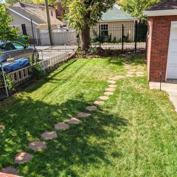 Jayscapes Landscaping Service - a backyard with a lawn and a fire pit - Landscaping Near Me