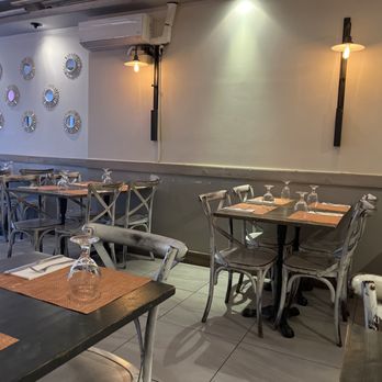Sahib - a dining area with tables and chairs - Indian Near Me - New York, New York