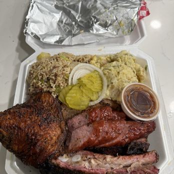 Flossie's BBQ - Three-meat platter with potato salad and dirty rice. - Barbeque Near Me - Houston, Texas