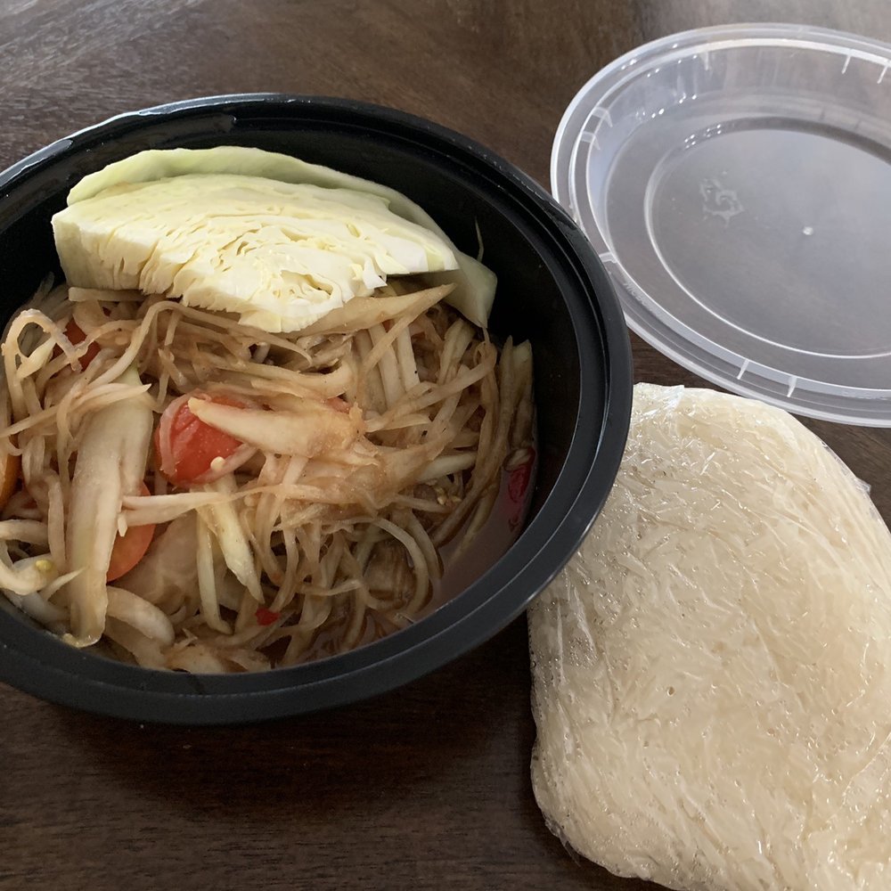 Papaya salad with 2 peppers. Not much spice to it. Rice on the side that comes with it.