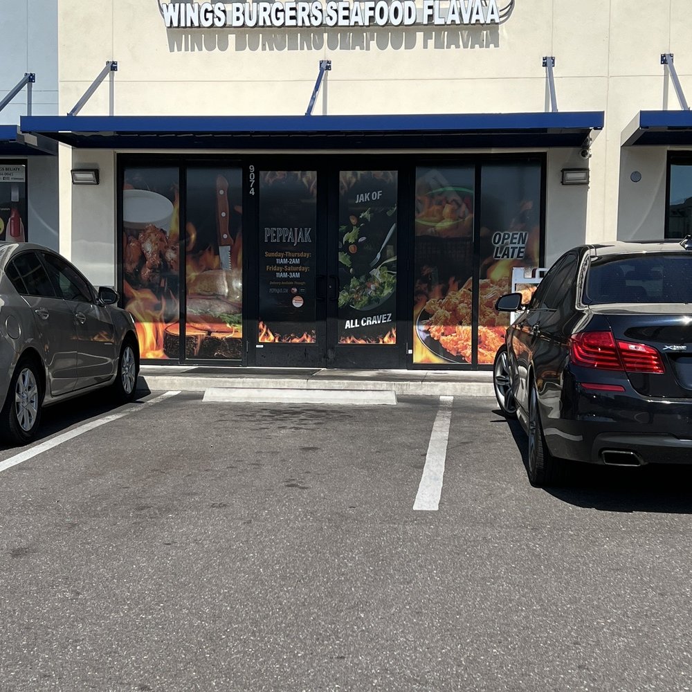 two cars parked in front of a restaurant