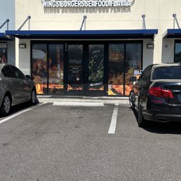 two cars parked in front of a restaurant