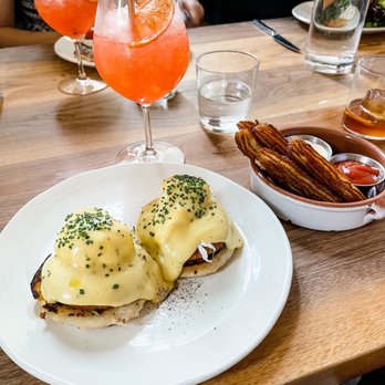 Martina - Crab cakes benedict, potato churros, pompelmo cocktail - Argentine Near Me - Minneapolis, Minnesota