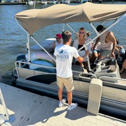 Unsalted Boat Rentals - Jordan familiarizing customers with the 17' Bennington pontoon.