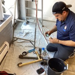 Rescue Plumbing - Plumber Javier working on a pipe repair.