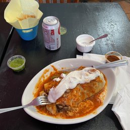 Carne asada wet burrito in red sauce. Don't forget the chips and crema. Carne asada wet burrito in red sauce. Don't forget the chips and crema.