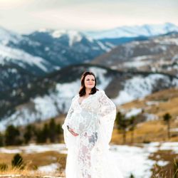 Sara Herkes Photography and Design - Mom-to-be standing in front of a gorgeous mountain landscape during her maternity photos near Boulder, CO