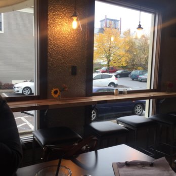 Hired Hand Brewing - a woman sitting at a table in a restaurant - Pizza Near Me - Vergennes, Vermont Hired Hand Brewing - a woman sitting at a table in a restaurant - Pizza Near Me - Vergennes, Vermont